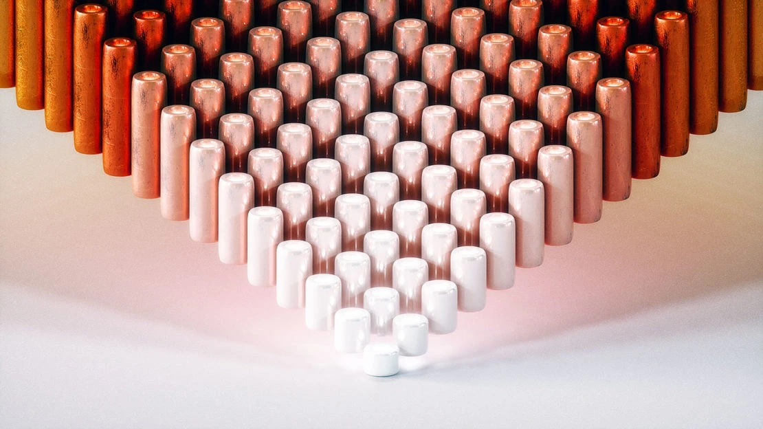 Organized cylinders of copper, rose gold, and white in a pattern on a white surface, casting shadows.