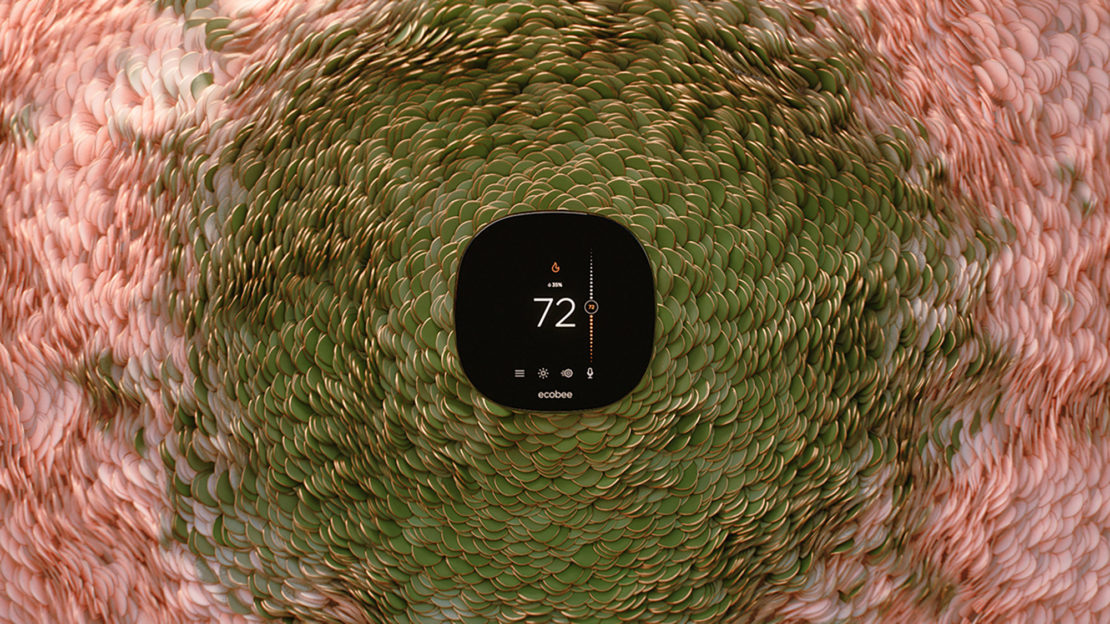 Close-up of a black Ecobee smart thermostat displaying 72 degrees, surrounded by green and pink scale-like textures.