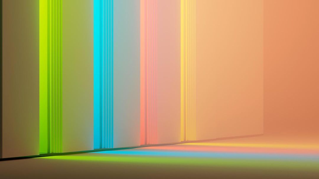 Abstract still life featuring pastel-colored paper sheets arranged vertically with colorful light reflections on the surface.