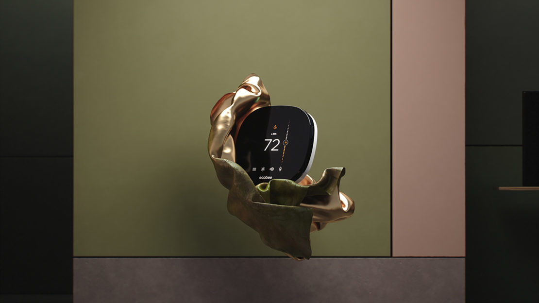 Smart thermostat displayed on a golden cloth, in front of a wall with pastel green and pink, promoting home climate control.