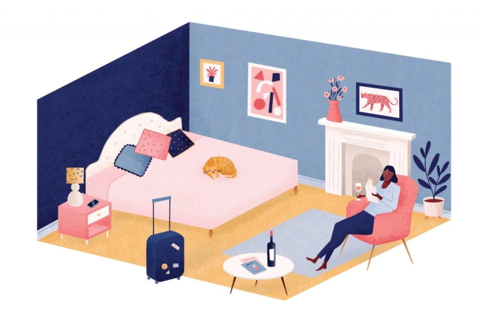 Illustration of a dark-haired woman reading in an armchair in a light blue bedroom with a pink bed, suitcase, and bedside table.