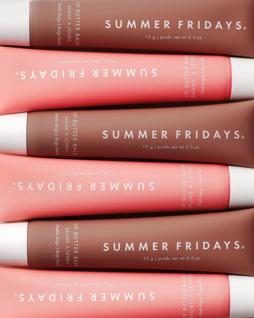 Cosmetic product still life: Close-up of Summer Fridays Lip Butter Balm tubes in pink and brown, stacked in a studio product shot.