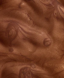 Macro close-up shot of shimmering metallic bronze cosmetic liquid texture with swirls.