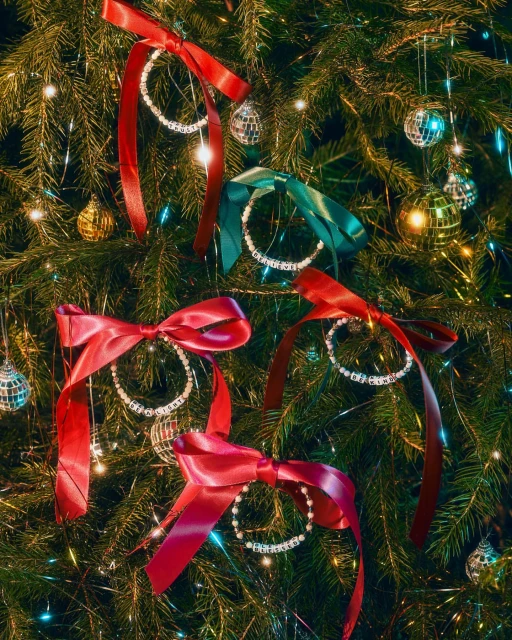 Festive Christmas tree adorned with ornaments, ribbon bows, and decorative baubles, creating a warm and inviting holiday atmosphere.