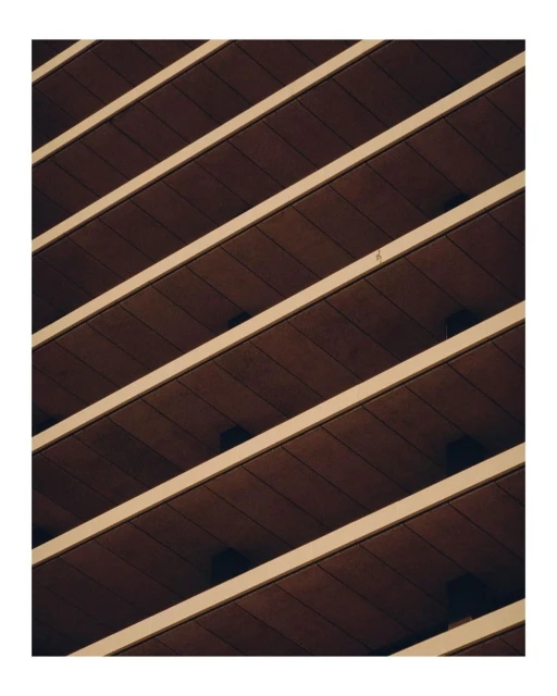 Oblique view showcases an architectural facade with horizontal brown panels and white structural elements, emphasizing geometric patterns.