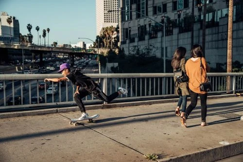 Portrait of Aaron Smith in a photo studio wearing a dark suit, dark turtleneck, and black glasses, with a gray background.