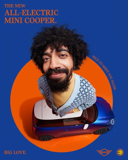 Person with an afro smiling above a blue Mini Cooper car, set against an orange and blue background in a studio shot.