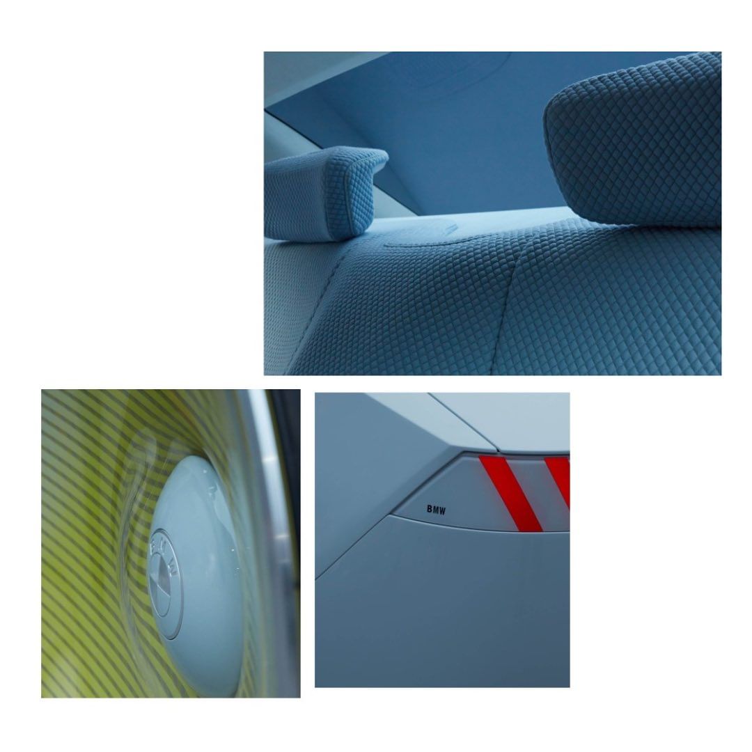 Close-up of car interior with blue seats, headrests, and detailing, plus a side mirror and rear lights.