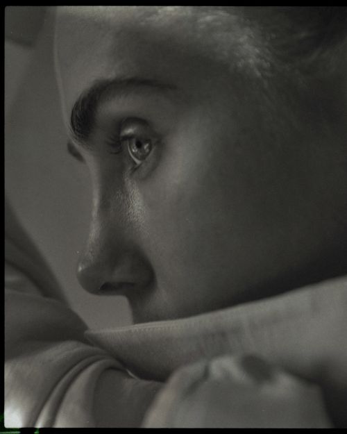 Close-up monochrome portrait profile of a person resting chin on crossed arms, shot by David Daub.