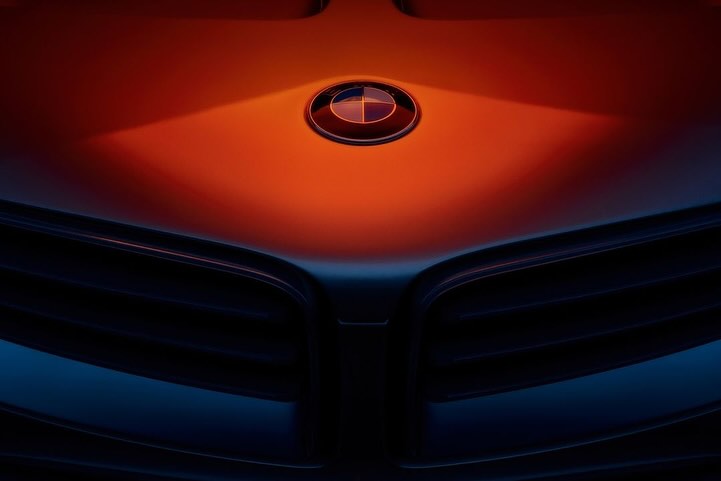 Close-up of a BMW car hood with the logo, highlighting the vehicle's design and brand identity against a gradient background.