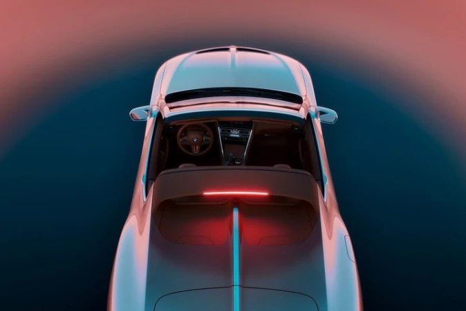 Top-down overhead view of a luxury convertible sports car with glowing red accent lighting and tan interior against a gradient background.