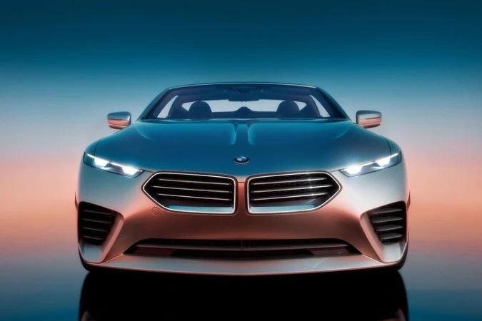 Front view of a silver BMW car with headlights on and a blue and orange gradient background, product shot, automotive photography.