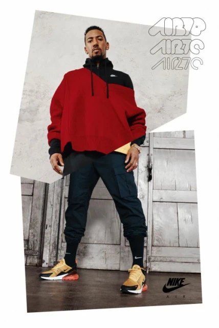 Athletic man in a red and black hoodie and joggers posing in a photo studio with Nike Air 270 sneakers and vintage paper overlays.