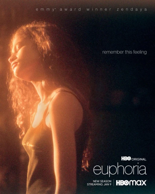 Zendaya is featured in a warm-toned, medium shot for the HBO series 'Euphoria', highlighting her profile in a brightly lit, dark setting.