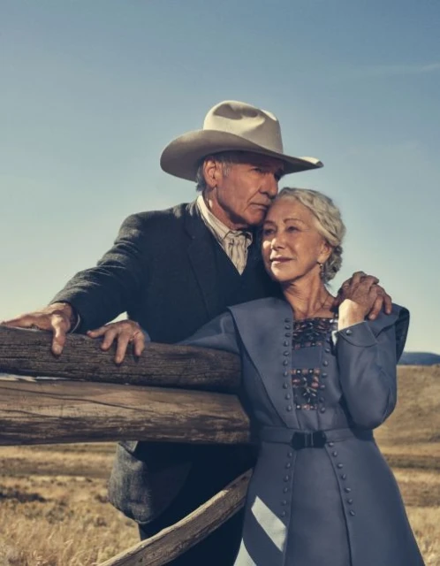 Helen Mirren and Harrison Ford in a promotional shot with a wooden fence, blue sky, and tan field in the background