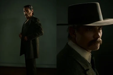 Two men in vintage period suits and hats posed dramatically against a dark studio background in a portrait photograph