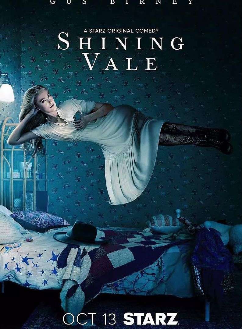 Promotional image for Shining Vale, featuring a woman floating in a bedroom with a bed, nightstand, wallpaper, and dim lighting.