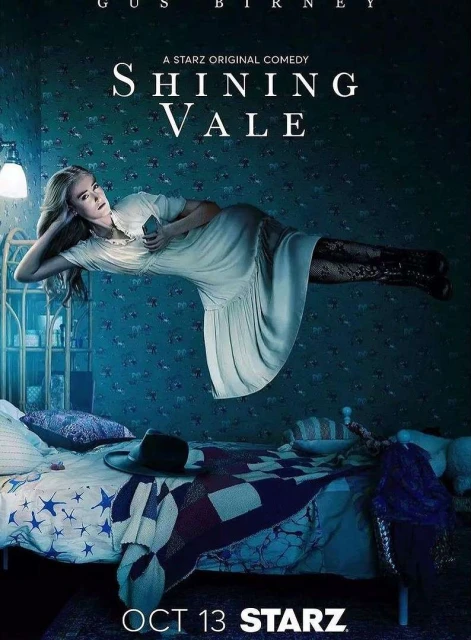 Promotional image for Shining Vale, featuring a woman floating in a bedroom with a bed, nightstand, wallpaper, and dim lighting.
