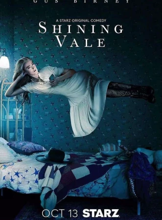 Promotional image for Shining Vale, featuring a woman floating in a bedroom with a bed, nightstand, wallpaper, and dim lighting.