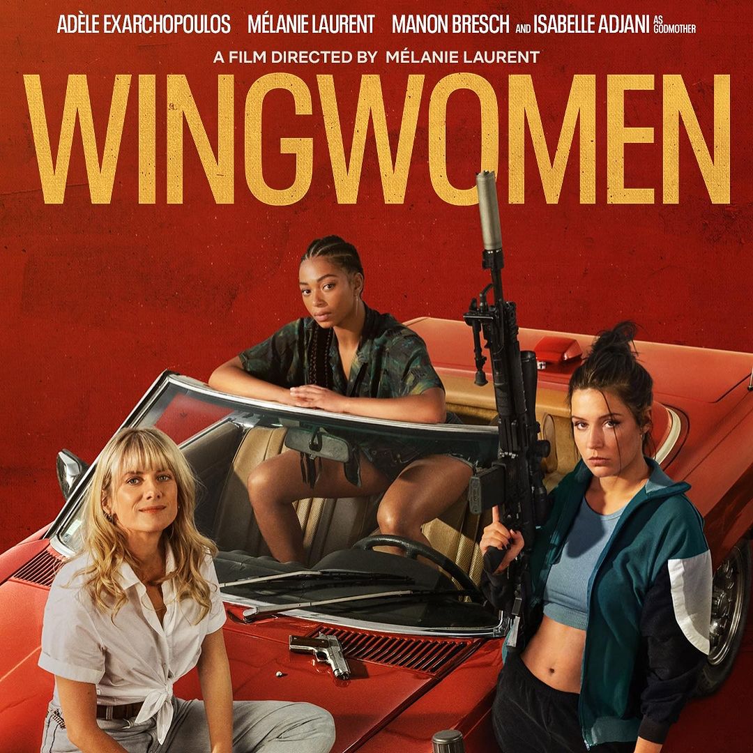 Movie poster for Wingwomen featuring three women in or around a red convertible car, with guns, against a red and orange backdrop.