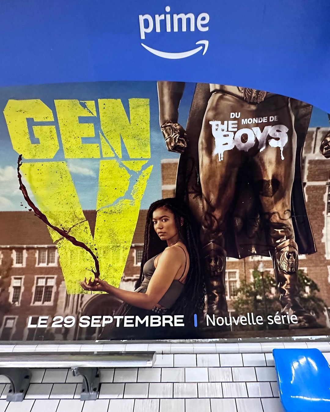 Gen V TV show promo poster in a subway station: Woman with long braids stands in front of building. Series launches September 29.