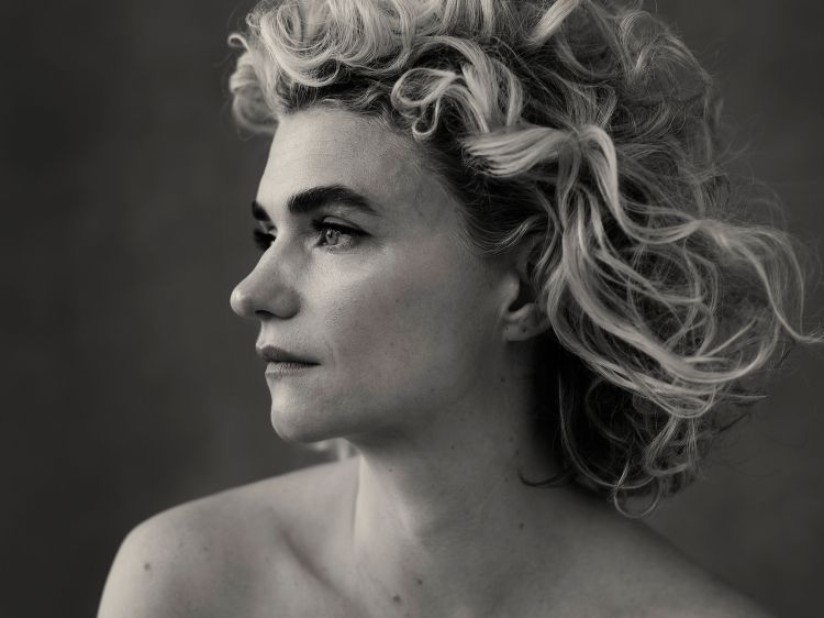 Monochrome portrait of a woman with curly hair in profile by photographer Victoria Will
