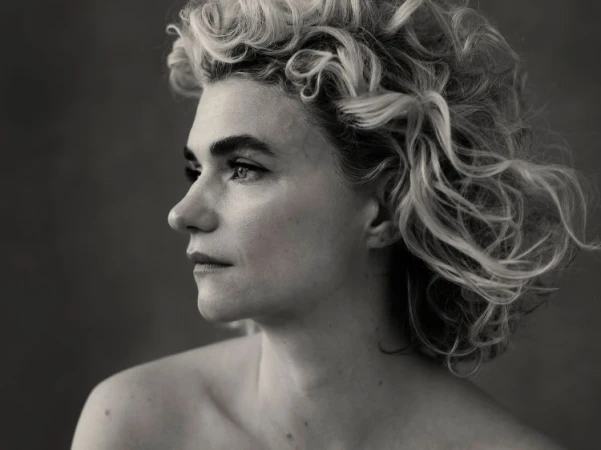 Monochrome portrait of a woman with curly hair in profile by photographer Victoria Will