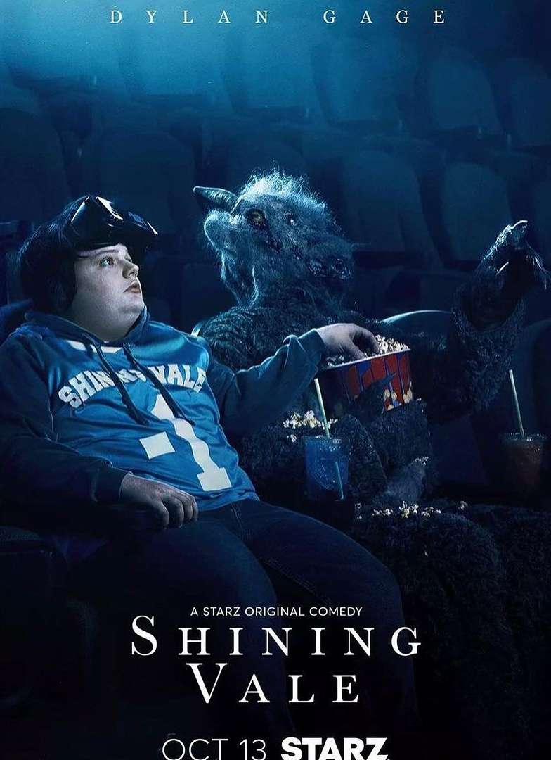 Promotional poster for Shining Vale featuring Dylan Gage in a movie theater next to a creature holding popcorn and a drink.