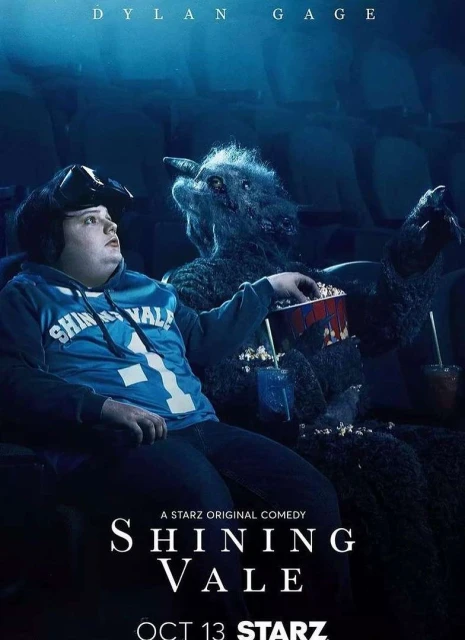 Promotional poster for Shining Vale featuring Dylan Gage in a movie theater next to a creature holding popcorn and a drink.