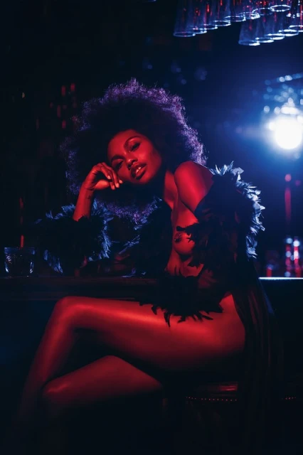 Portrait of a black woman with afro hair sitting at a bar, wearing a feather boa, lit by red and blue lights, artistic photography.