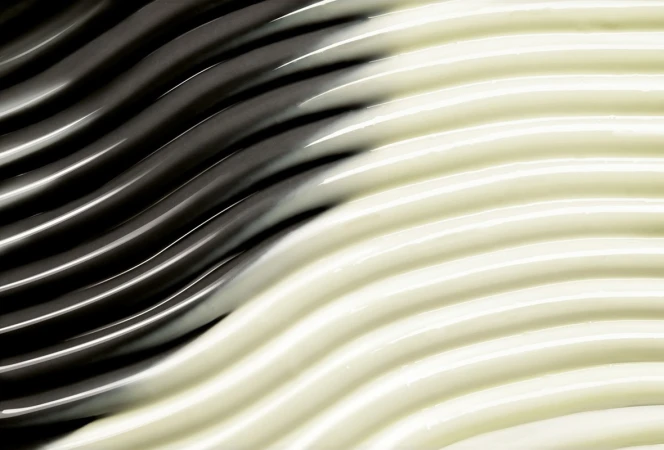 Abstract wavy texture in dark gray and light beige, creating a smooth and fluid pattern suitable for backgrounds.
