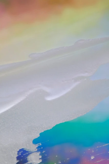 Abstract background image featuring flowing textures with an iridescent color palette of pink, yellow, grey, blue, and teal.