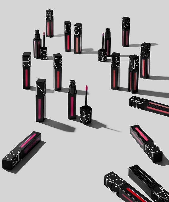 Multiple NARS brand lipsticks are displayed against a white background, some are standing and others are lying down in the image.
