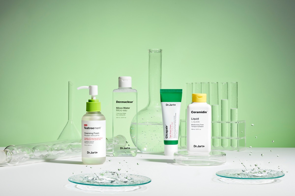 Still life of Dr.Jart+ skincare products including cleansers, toners, and moisturizers, arranged with laboratory glassware on a white surface.