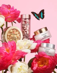 Elizabeth Arden skincare products arranged among bright pink and white peony flowers with a blue butterfly against pink background
