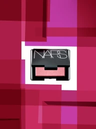 NARS makeup compact against a geometric pink and burgundy overlapping rectangular background pattern