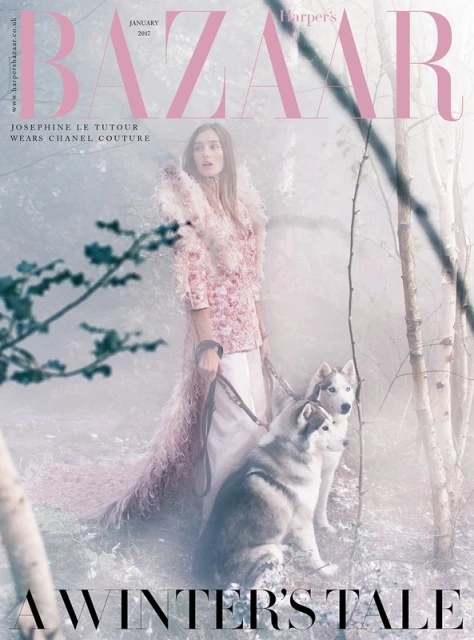 Bazaar cover: A woman in floral couture walks two husky dogs in a misty winter forest, fashion photography.