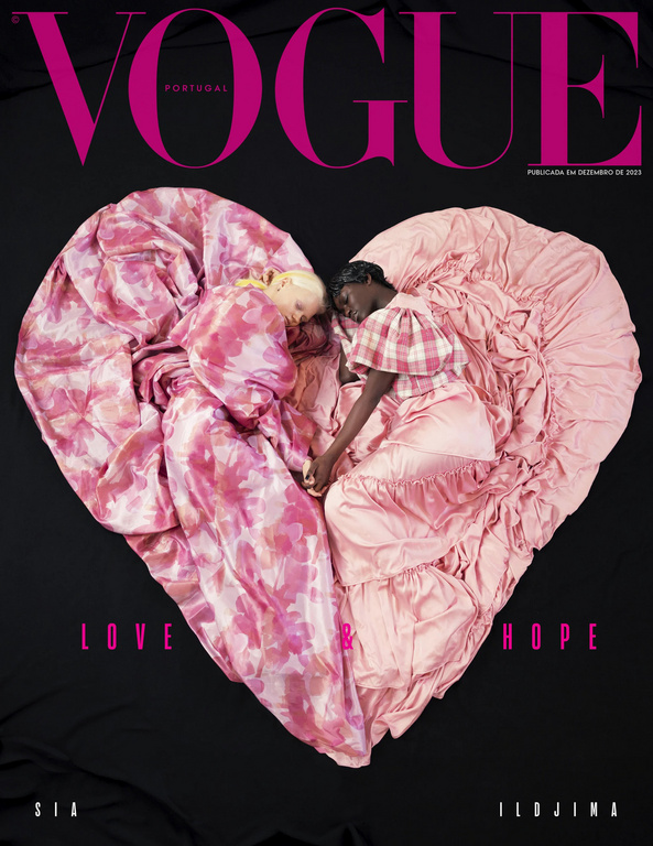 Vogue Portugal cover featuring two models lying head-to-head, covered by pink and white floral-patterned fabric in a heart shape.