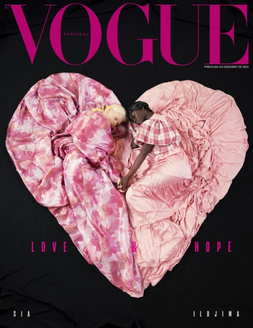 Vogue Portugal cover featuring two models lying head-to-head, covered by pink and white floral-patterned fabric in a heart shape.