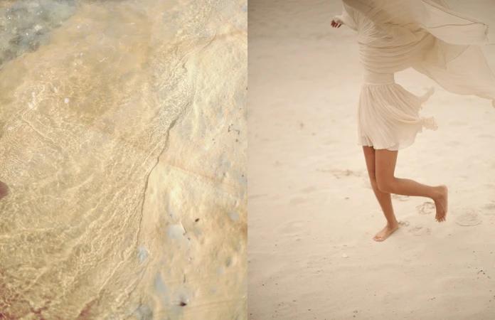Close-up split view of shallow rippling water over sand and a person walking barefoot in a light dress on a sandy beach.