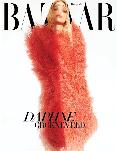 Fashion editorial cover for Harper's Bazaar magazine featuring Daphne Groeneveld wearing a coral shaggy coat on a white backdrop.