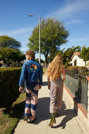 Two people walking away on a sunny suburban sidewalk, styled by Alison Lewis in Los Angeles