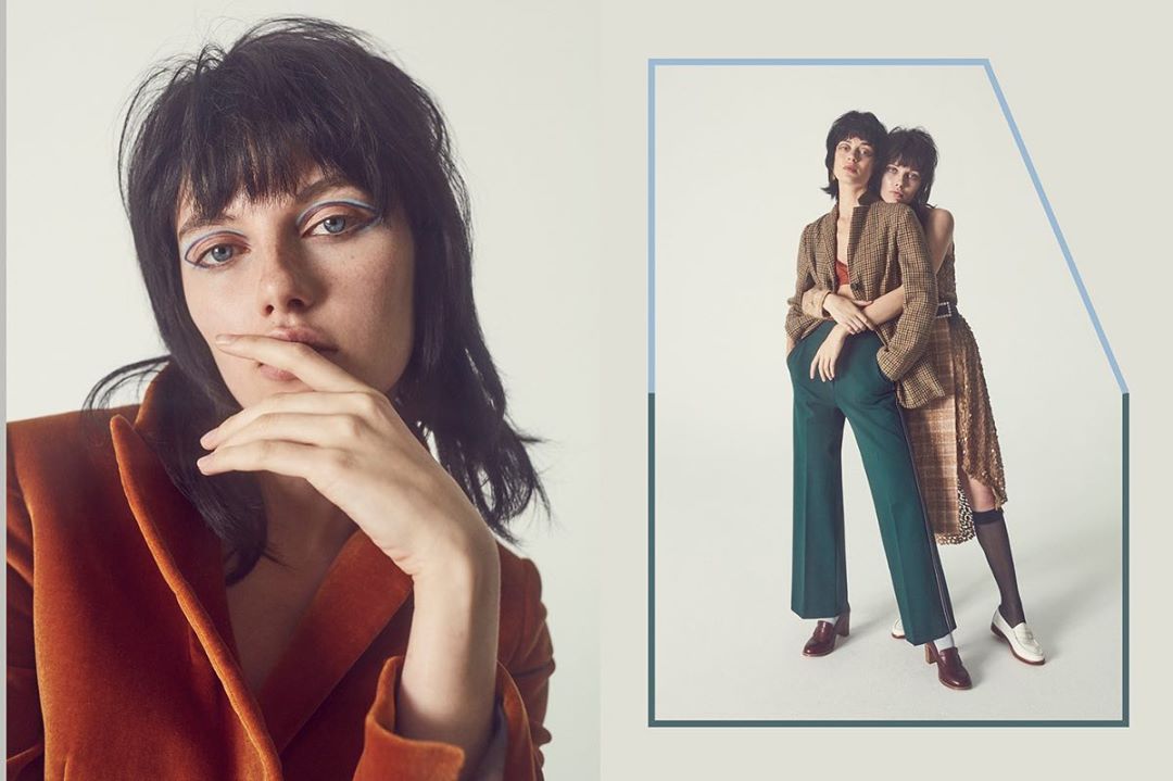 Two young women in blazers and trousers pose in a studio. One is a close up head shot. Fashion photography with makeup.