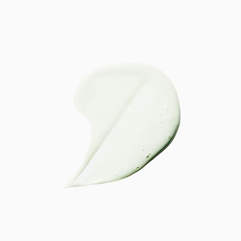 Close-up of a semi-transparent, light green gel smear on a clean white surface, highlighting its texture and smooth application.