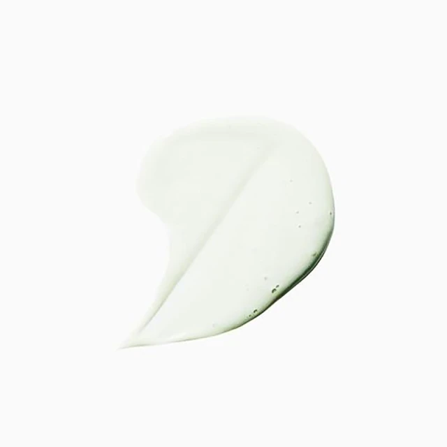Close-up of a semi-transparent, light green gel smear on a clean white surface, highlighting its texture and smooth application.