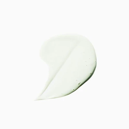 Close-up of a semi-transparent, light green gel smear on a clean white surface, highlighting its texture and smooth application.
