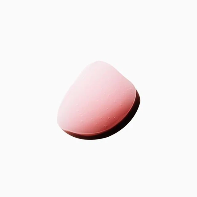 Close-up studio shot of a makeup sponge applicator, pink colored, on a white background, beauty and makeup product.