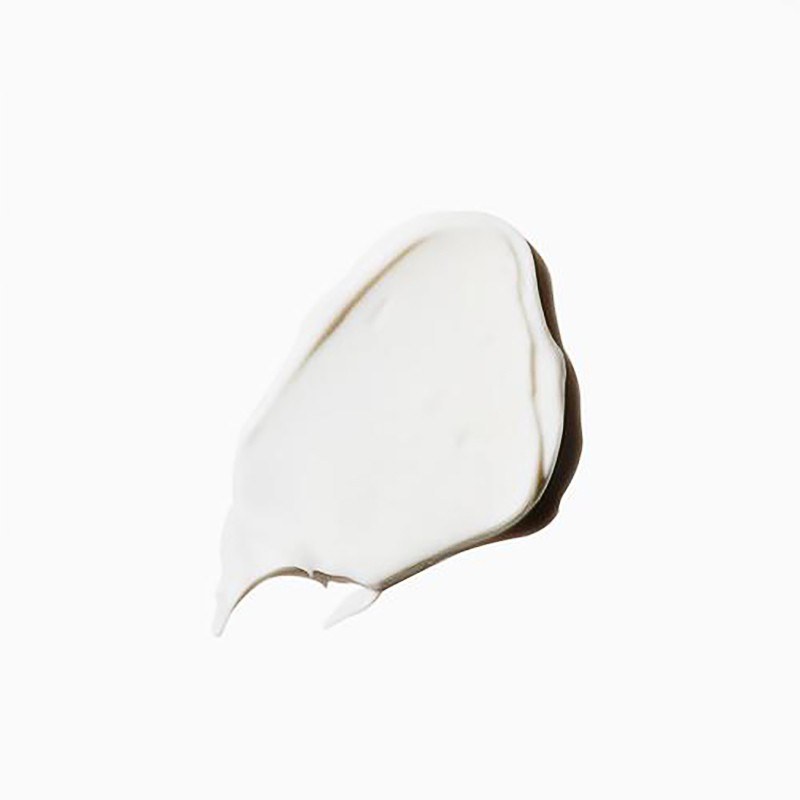 Close-up of a dollop of white cream or lotion on a white background, showcasing its smooth texture and light-reflecting qualities.
