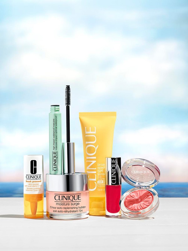 Clinique beauty product collection featuring skincare and makeup items against a blurred beach background for brand advertising and promotion.