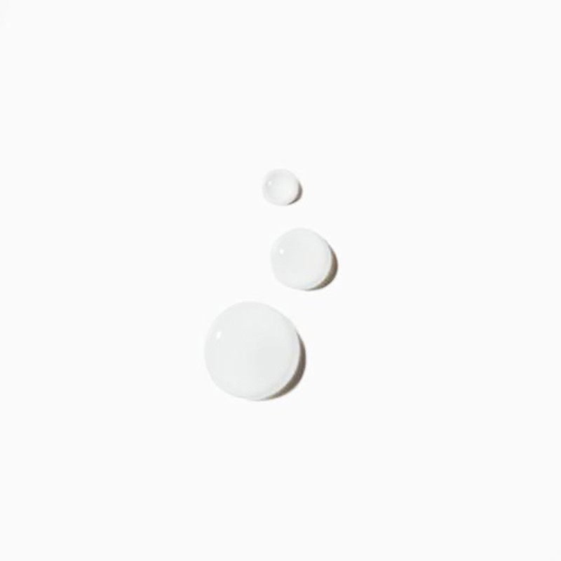 Three drops of translucent liquid are arranged on a bright white surface with subtle shadows underneath each drop.